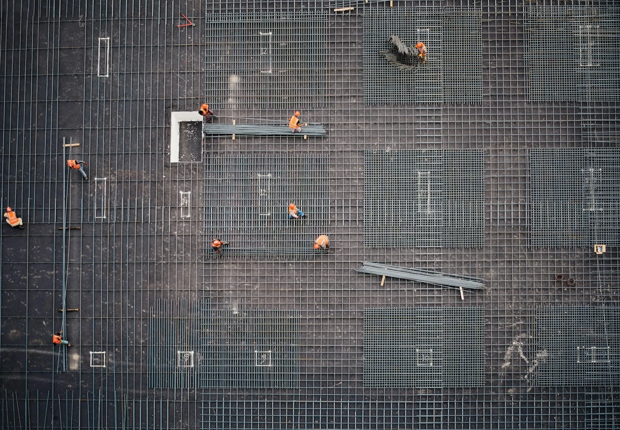 Aerial view of construction workers placing rebar for a large concrete foundation