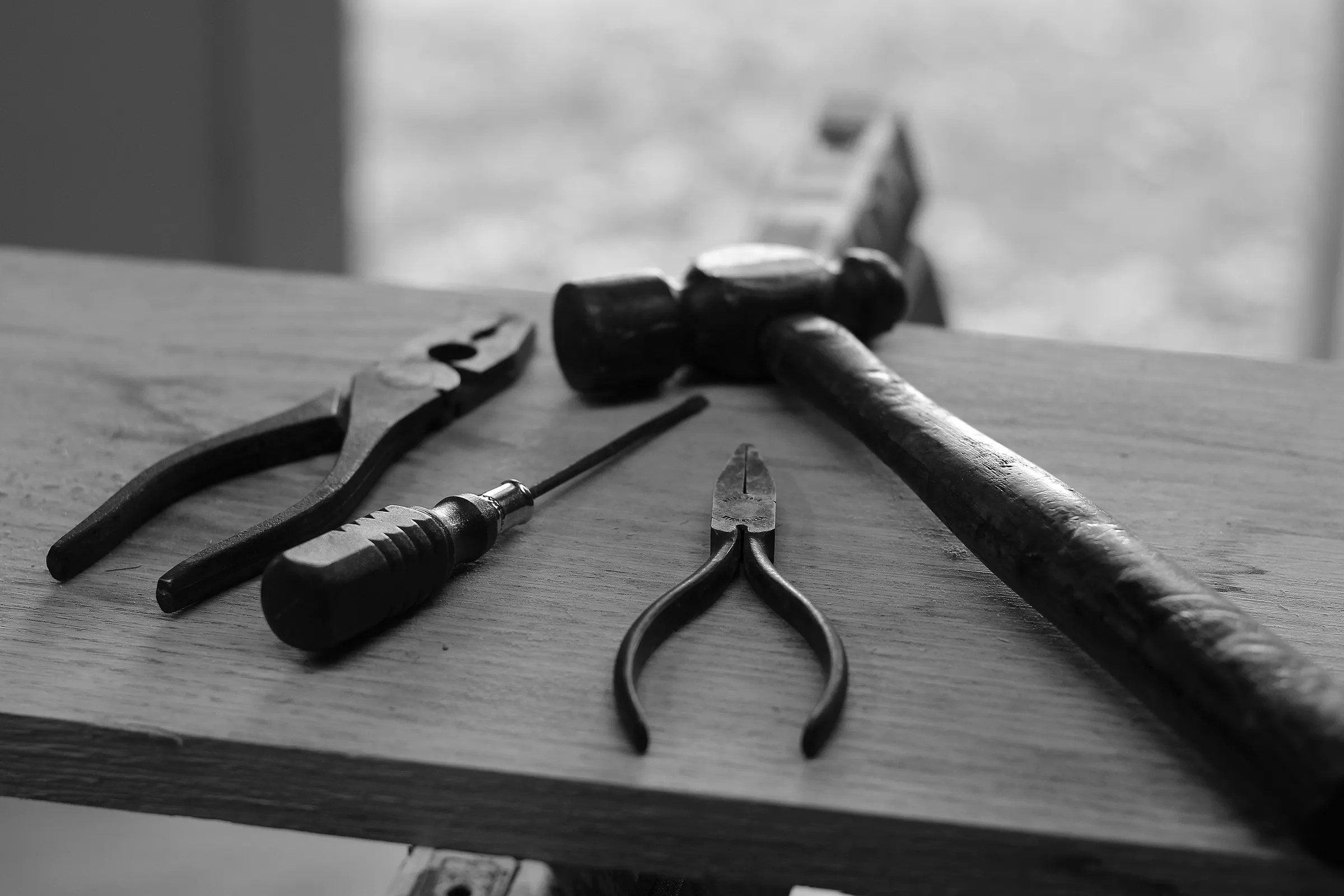 Hand tools resting on a workbench